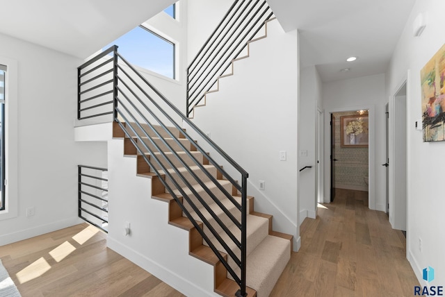 stairway with hardwood / wood-style floors