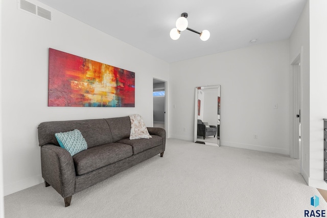 living room featuring an inviting chandelier and carpet