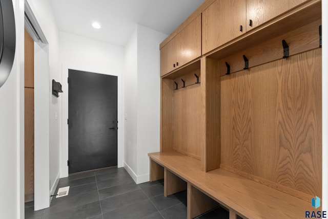 mudroom featuring dark tile patterned floors