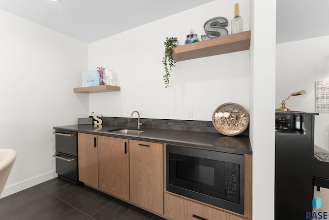 kitchen with sink, black microwave, and dark tile patterned floors