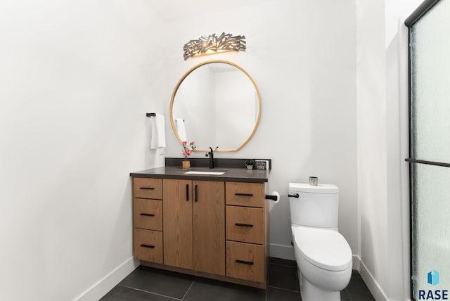 bathroom with vanity, tile patterned flooring, and toilet