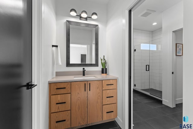 bathroom featuring vanity, walk in shower, and tile patterned flooring