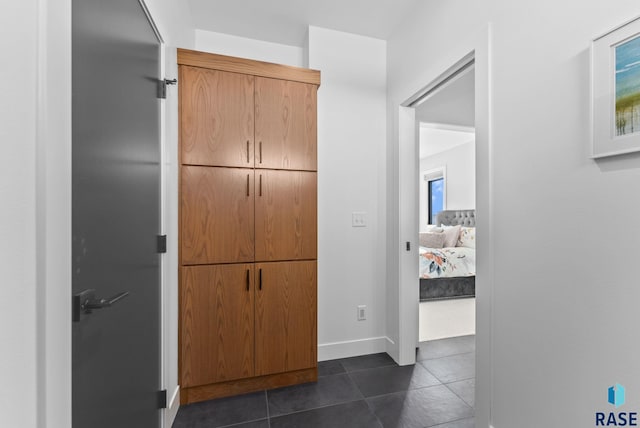 corridor with dark tile patterned floors