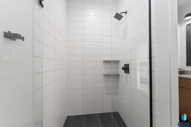 bathroom with sink and tiled shower