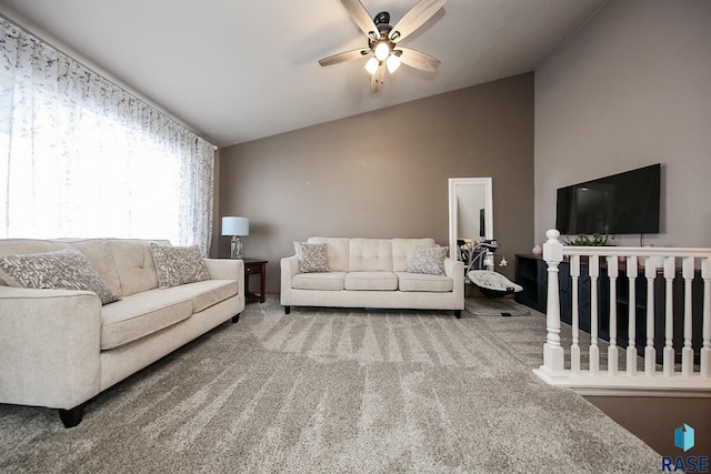 living room featuring ceiling fan, lofted ceiling, and carpet