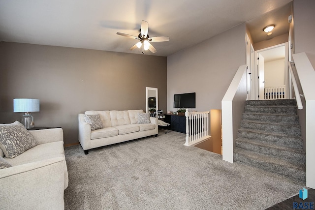 carpeted living room with ceiling fan