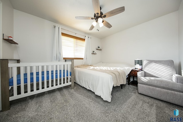 bedroom featuring ceiling fan and dark carpet