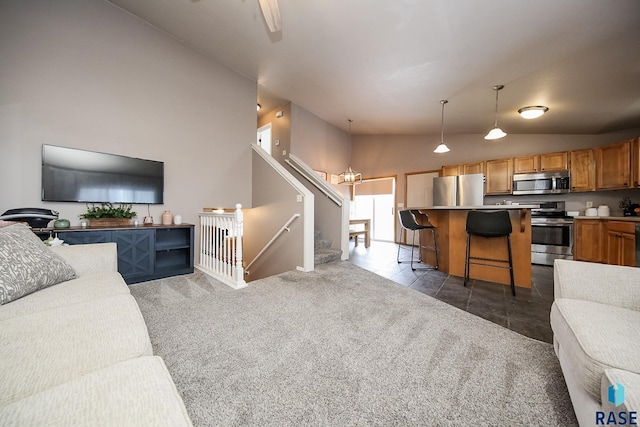 carpeted living room featuring lofted ceiling