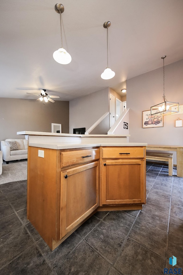 kitchen with ceiling fan, pendant lighting, and a kitchen island