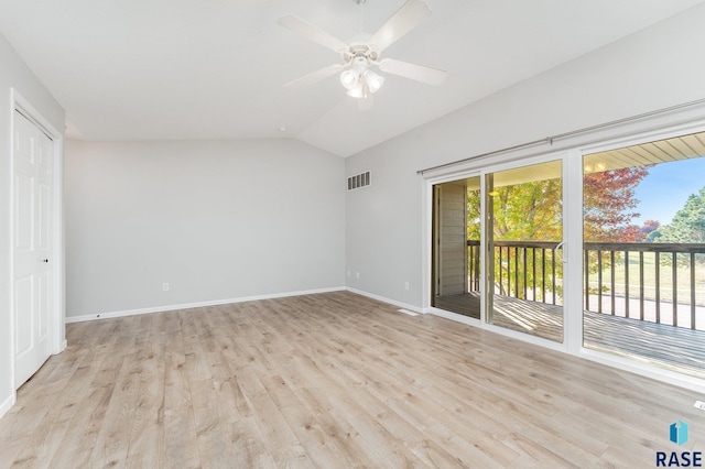 spare room featuring ceiling fan, light wood-type flooring, and lofted ceiling