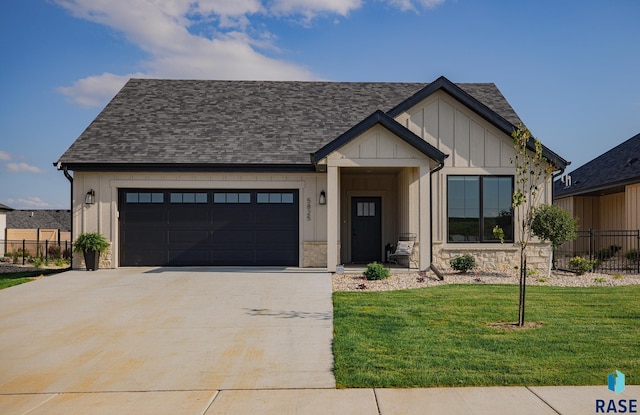 view of front of house with a garage and a front lawn