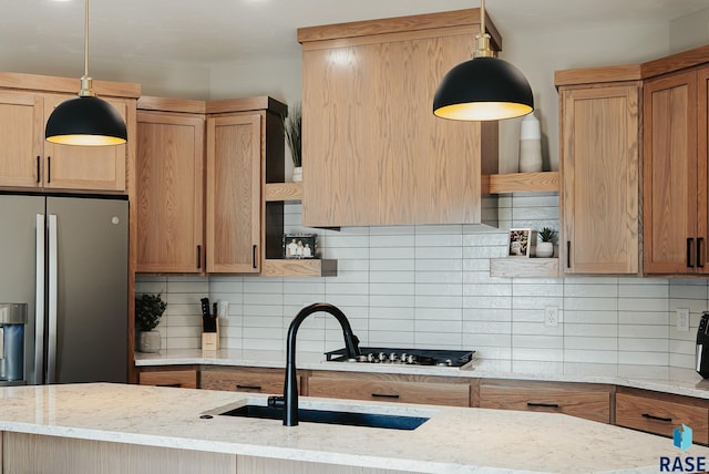 kitchen with decorative light fixtures, decorative backsplash, and light stone countertops