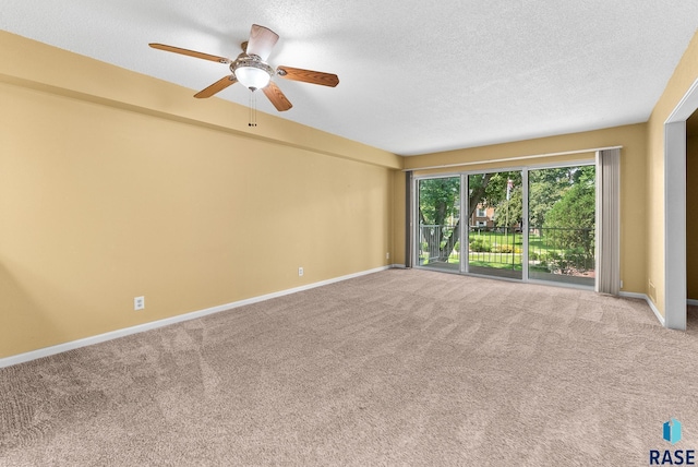 unfurnished room with a textured ceiling, light carpet, and ceiling fan