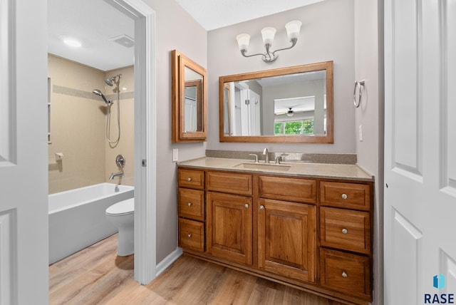 full bathroom with toilet, wood-type flooring, vanity, and tub / shower combination