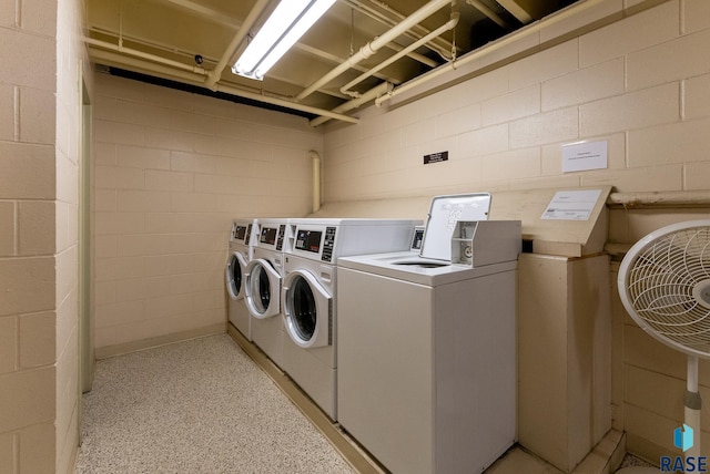 clothes washing area with washer and clothes dryer