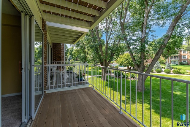 wooden terrace featuring a yard