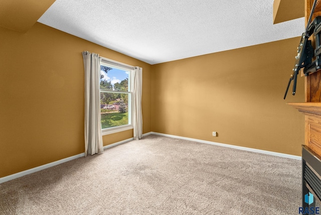 unfurnished living room featuring a textured ceiling and carpet