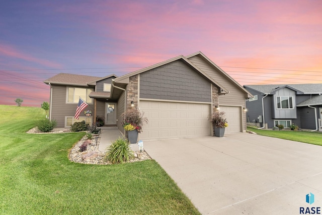 view of front of house with a yard and a garage