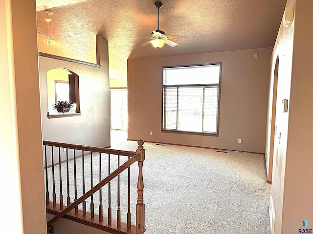 interior space featuring carpet flooring and a textured ceiling