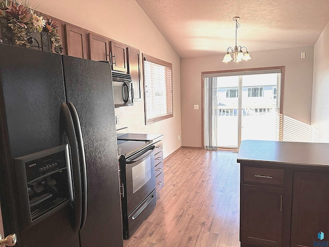 kitchen with decorative light fixtures, black appliances, a chandelier, and dark brown cabinetry