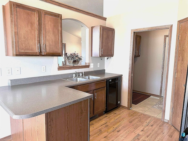 kitchen featuring sink, light wood-type flooring, dishwasher, and kitchen peninsula