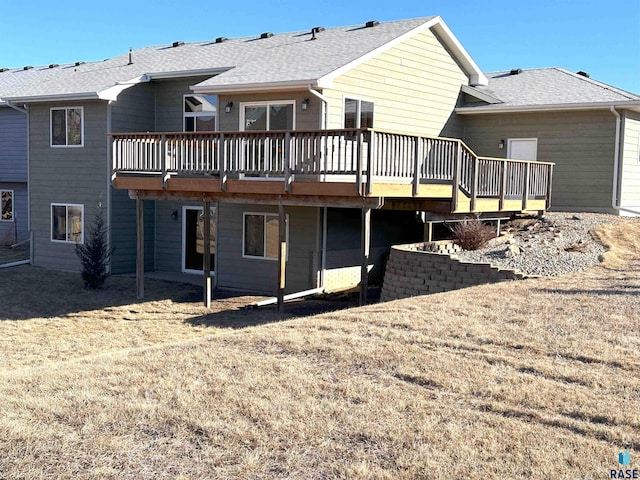 rear view of property featuring a wooden deck