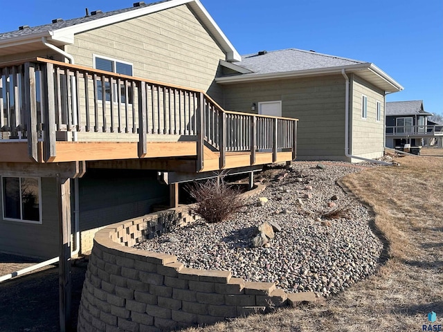 rear view of house featuring a wooden deck