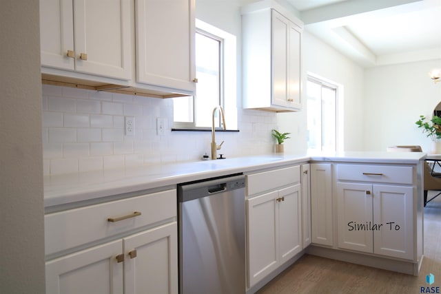 kitchen featuring dishwasher, decorative backsplash, white cabinets, light hardwood / wood-style flooring, and sink