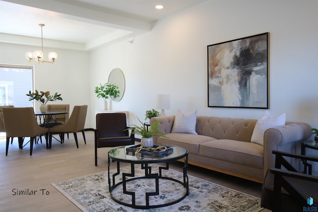 living room featuring an inviting chandelier and light wood-type flooring