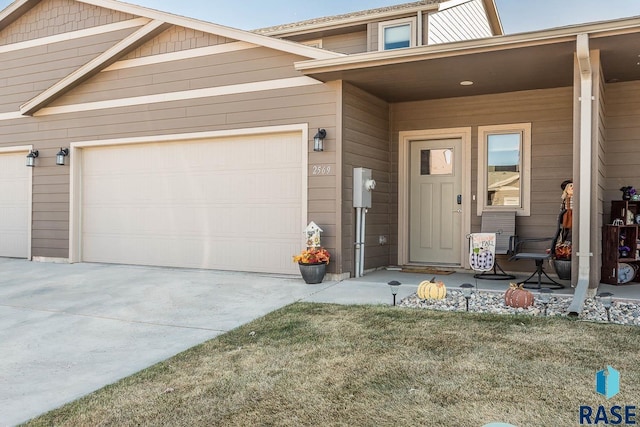 entrance to property with a lawn