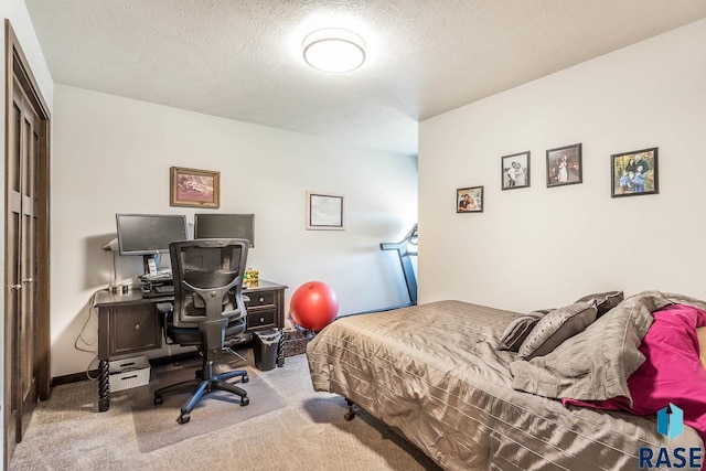 carpeted bedroom featuring a textured ceiling