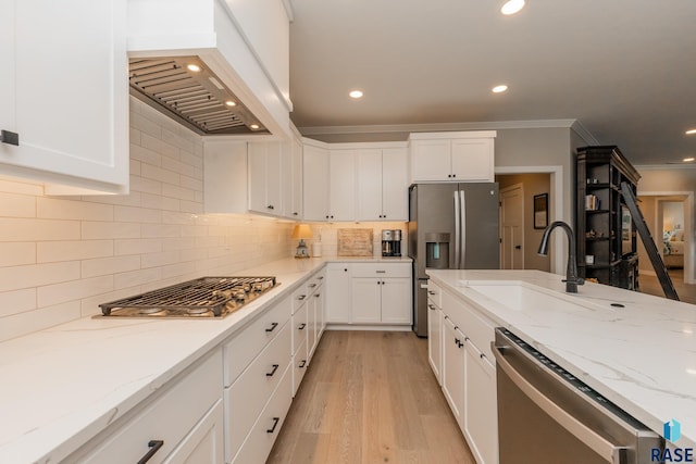 kitchen with white cabinets, custom exhaust hood, tasteful backsplash, and stainless steel appliances