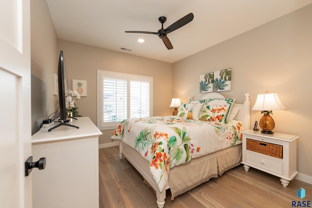 bedroom with ceiling fan and hardwood / wood-style flooring