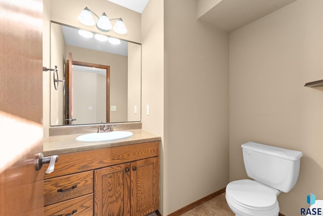 bathroom featuring toilet, tile patterned flooring, and vanity