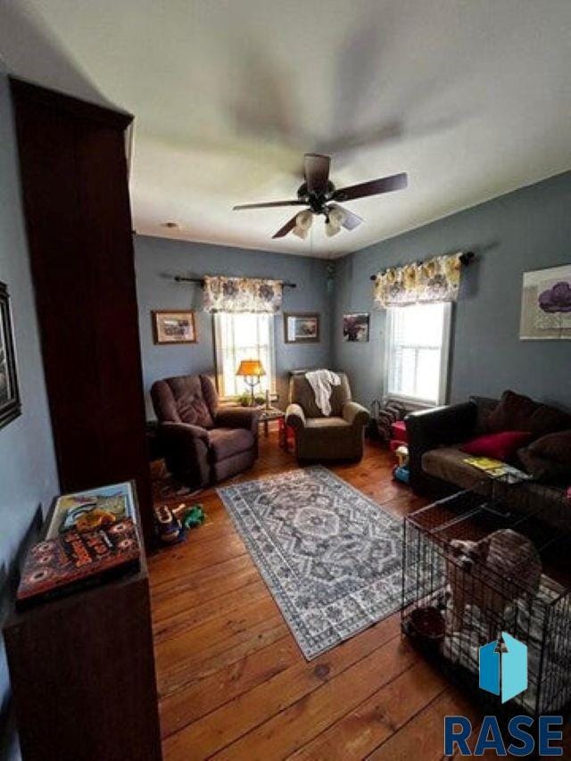 living room with ceiling fan and hardwood / wood-style floors