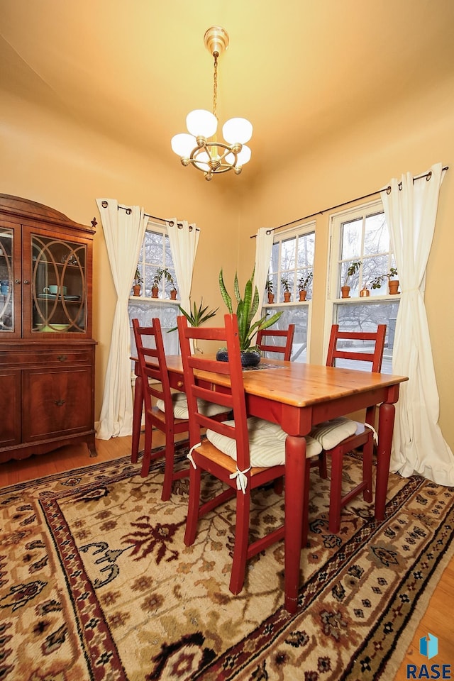 dining room featuring hardwood / wood-style floors and an inviting chandelier