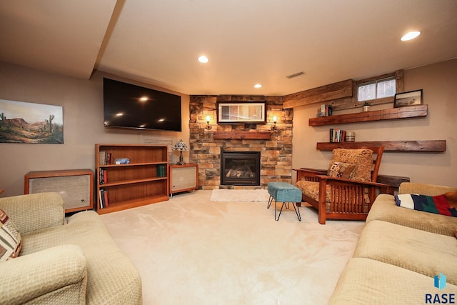 living room featuring light carpet and a stone fireplace