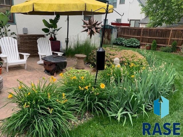 view of yard featuring an outdoor fire pit and a patio