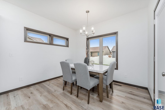 dining room featuring a chandelier and light hardwood / wood-style flooring