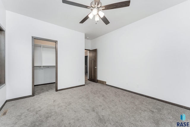 unfurnished bedroom featuring ceiling fan, a closet, and light carpet