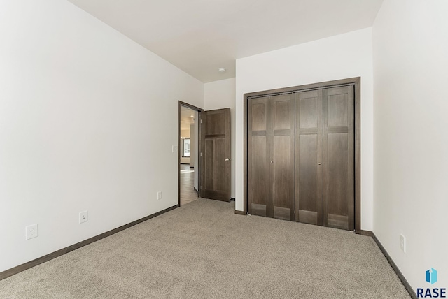 unfurnished bedroom with a closet and carpet