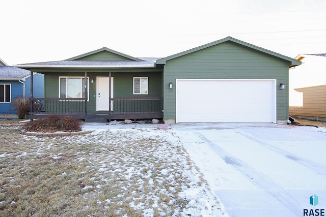 ranch-style house featuring covered porch and a garage