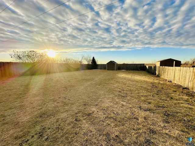 yard at dusk with a storage shed