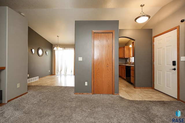 interior space featuring vaulted ceiling, a chandelier, and sink