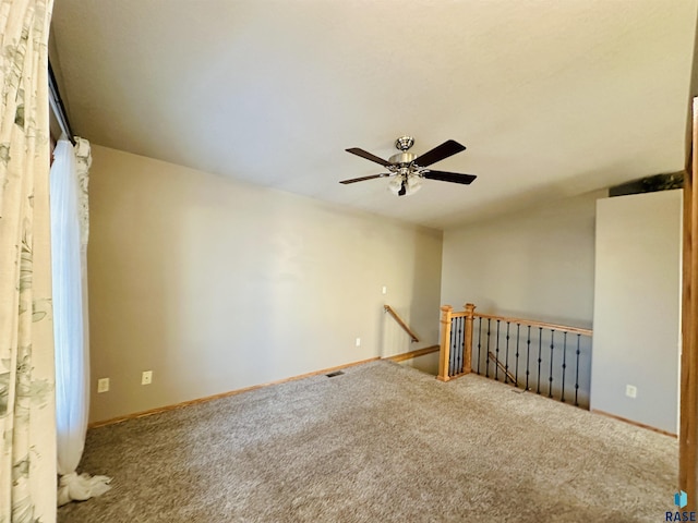 carpeted empty room featuring ceiling fan