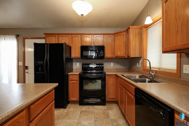 kitchen featuring decorative light fixtures, sink, light tile patterned floors, and black appliances