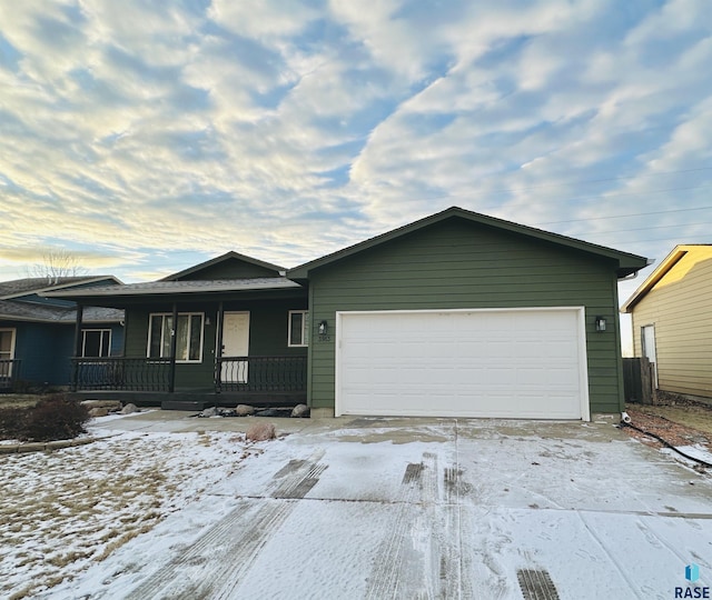 ranch-style home featuring a garage and covered porch