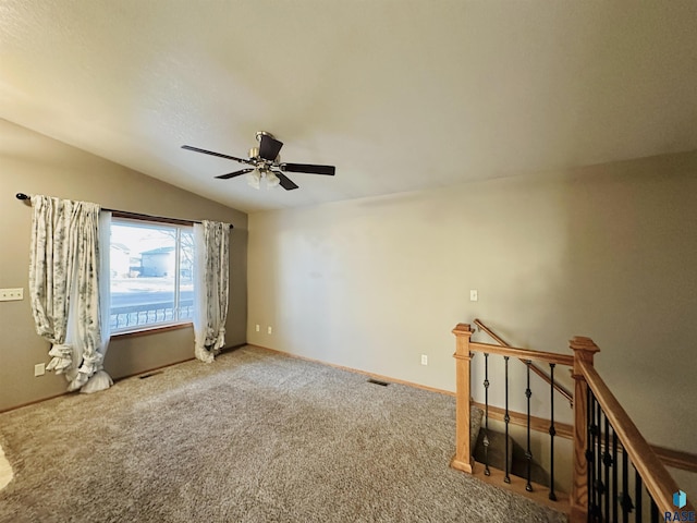 empty room with ceiling fan, carpet, and vaulted ceiling