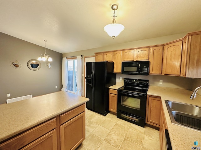 kitchen with a notable chandelier, black appliances, sink, light tile patterned flooring, and hanging light fixtures