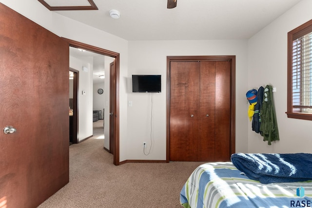 bedroom with light carpet, a closet, and ceiling fan